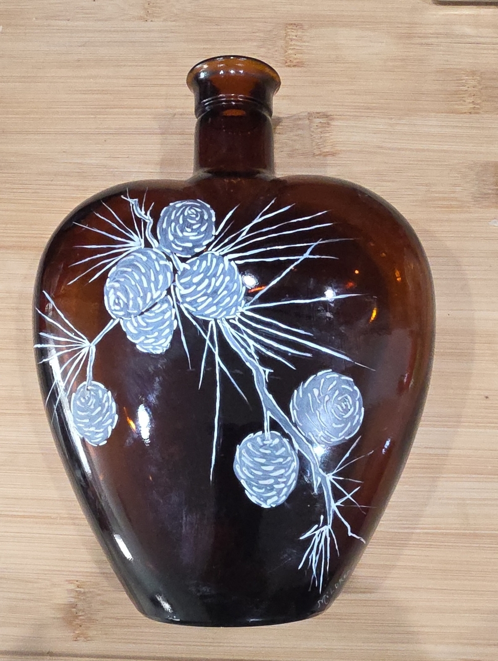 Amber Glass Decorative Flask with White Pinecone Motif On Piece Of History.